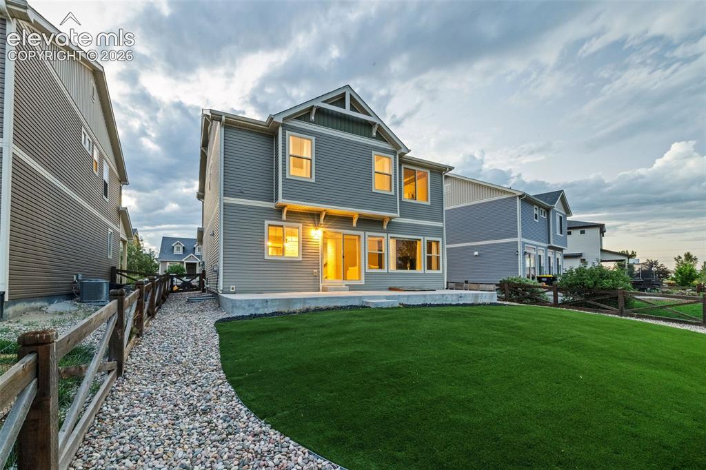 Image 36 of 48: Artifical turf in the fully fenced back yard keeps the yard green year-roun
