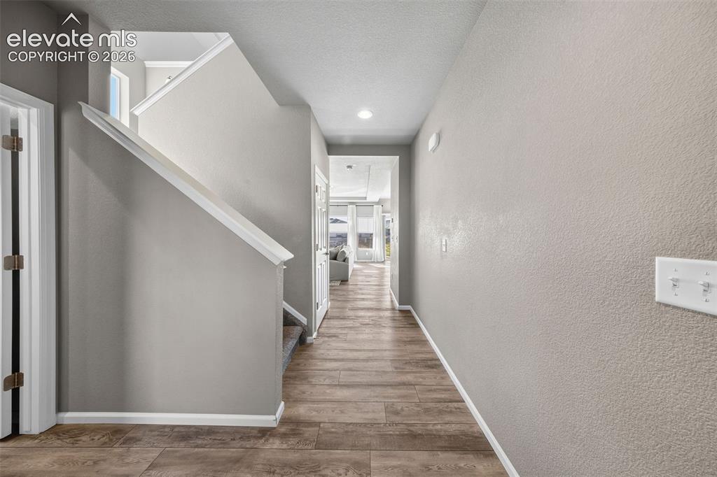 Image 4 of 48: The front entry is filled with light and is spacious enough for a drop stat