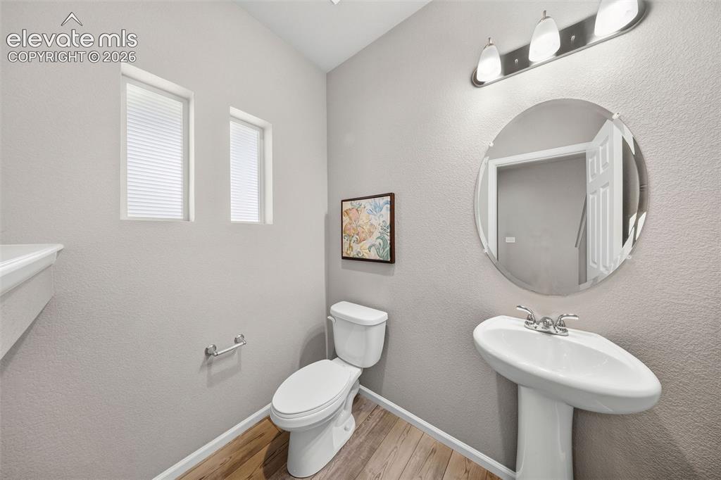 Image 6 of 48: This spacious half bath is right off the entry and serves guests with style
