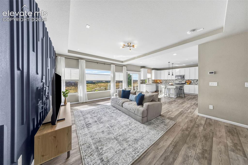 Image 9 of 48: The living room has this incredible feature wall and if you peek back behin