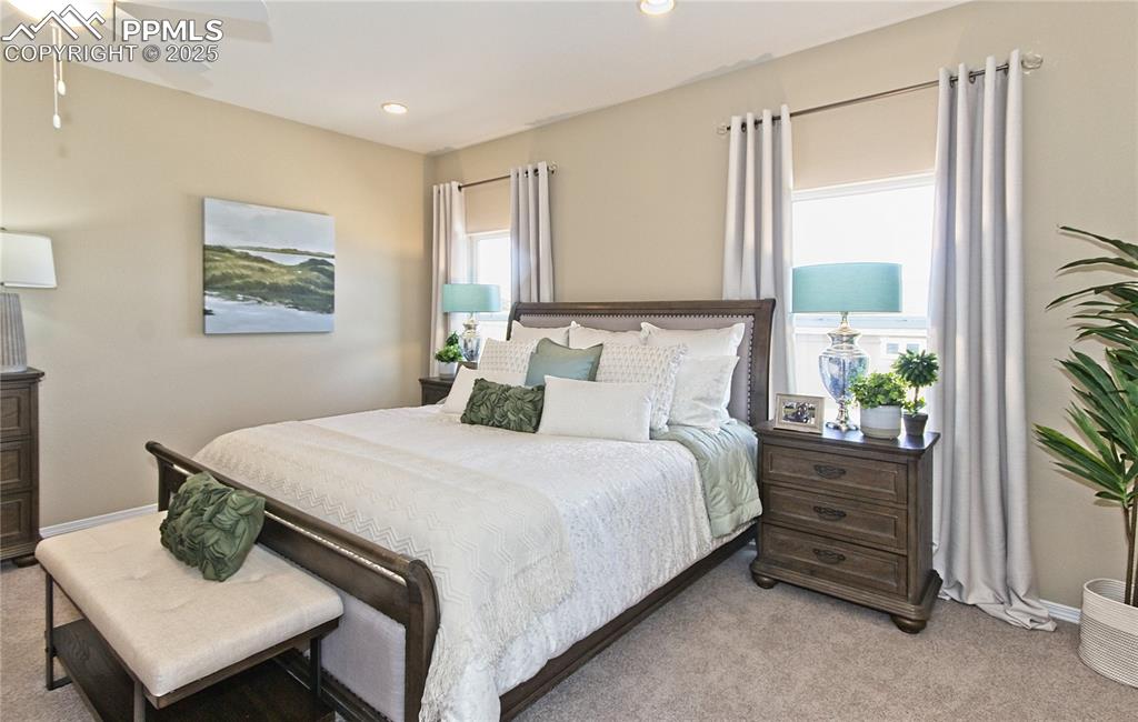 Image 22 of 30: Bedroom featuring light colored carpet, recessed lighting, and a ceiling fa