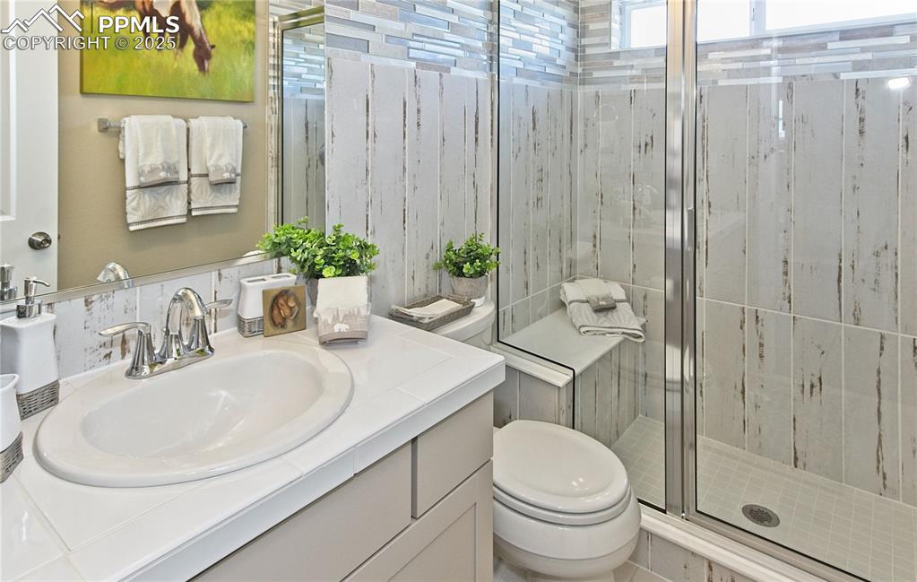 Image 5 of 30: Full bath featuring a shower stall and vanity