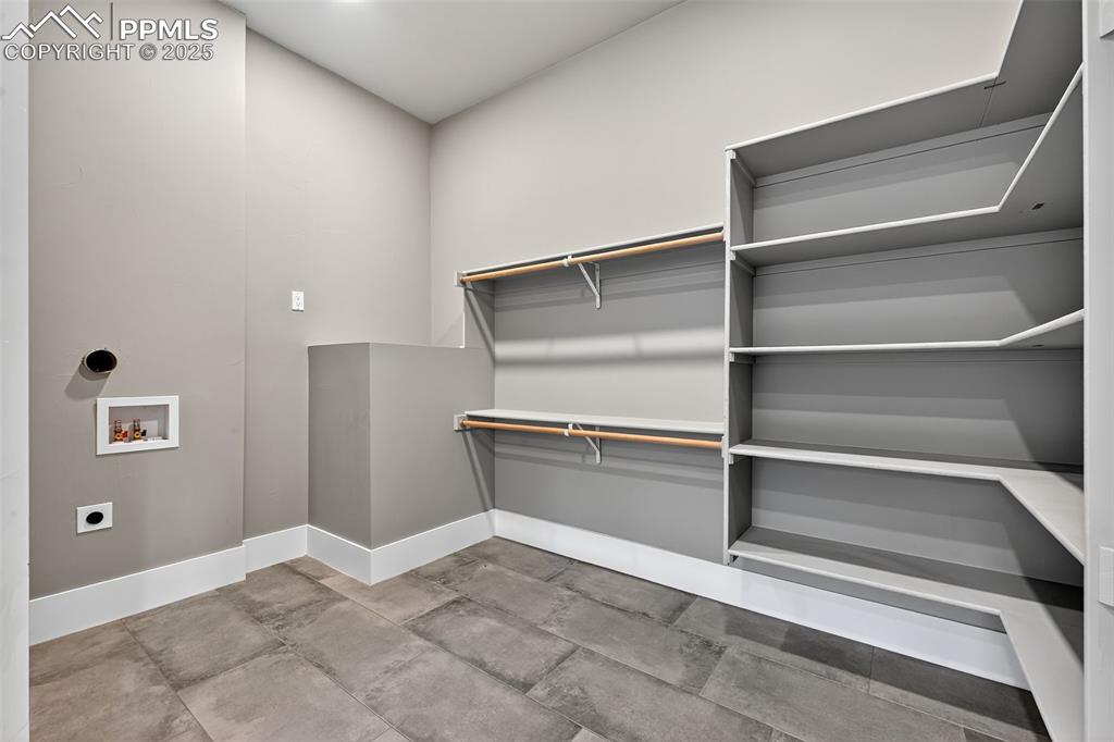 Image 20 of 50: Laundry room with electric dryer hookup, hookup for a washing machine, and