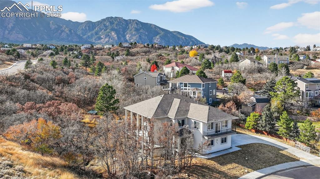 Image 47 of 50: Aerial perspective of suburban area with a mountainous background