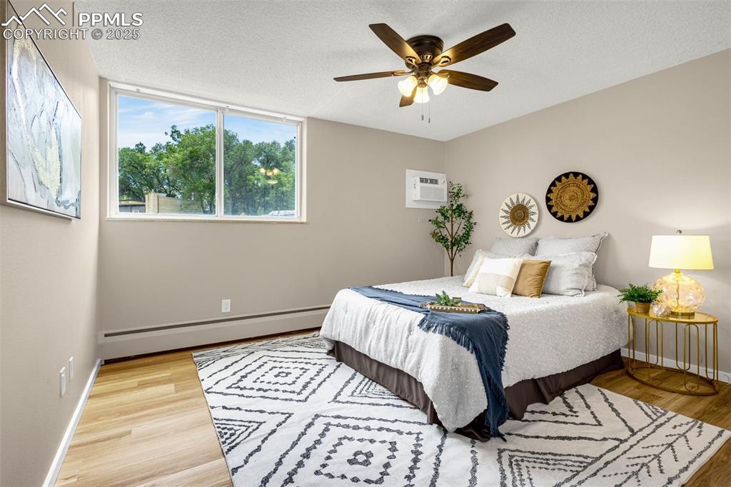 Image 7 of 14: Primary Bedroom with Wall AC unit and new ceiling fan