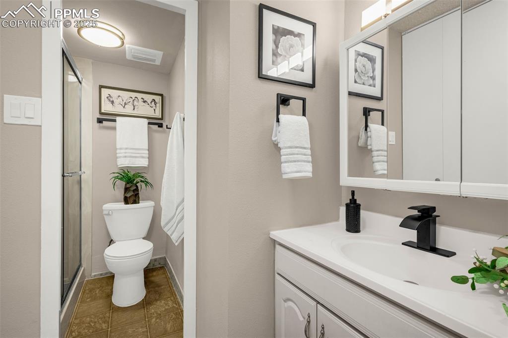 Image 8 of 14: Primary Bathroom has separate vanity and free-standing shower plus HUGE clo