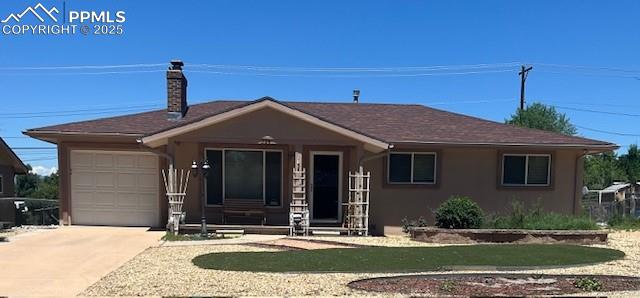 Caption: Ranch-style house with an attached garage, concrete driveway, a chimney, and stucco siding