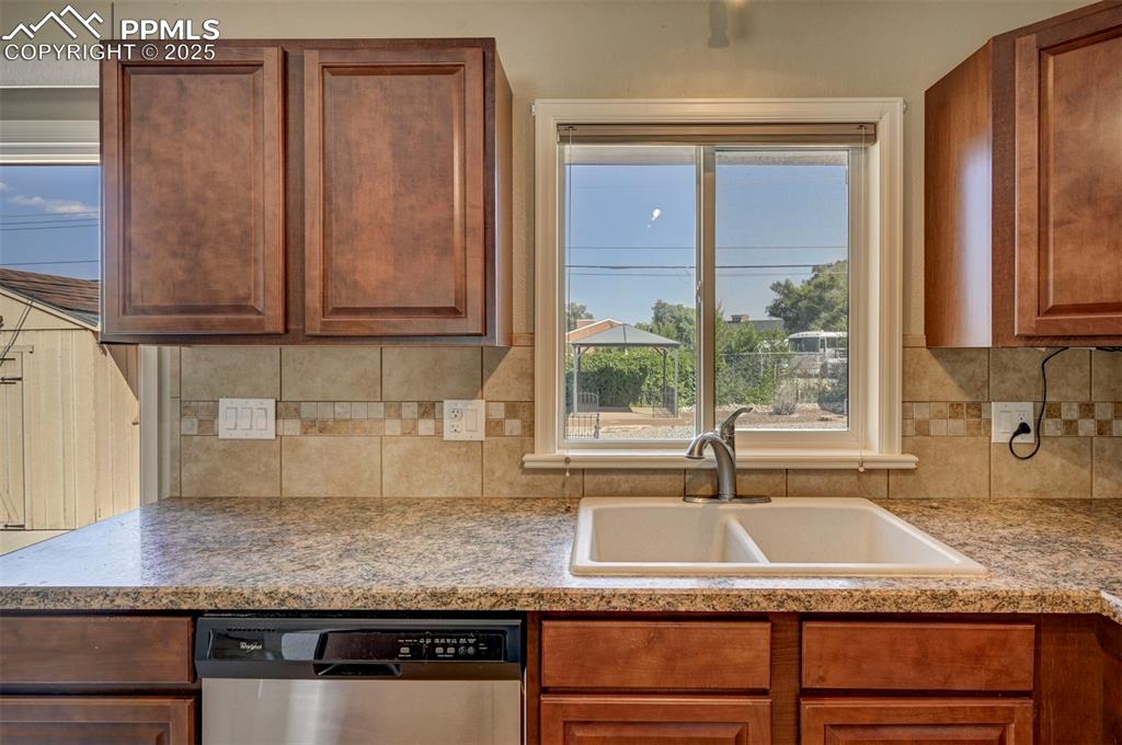 Image 14 of 33: Kitchen featuring stainless steel dishwasher, healthy amount of natural lig
