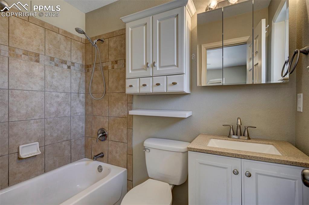 Image 21 of 33: Full bath with vanity and  shower combination