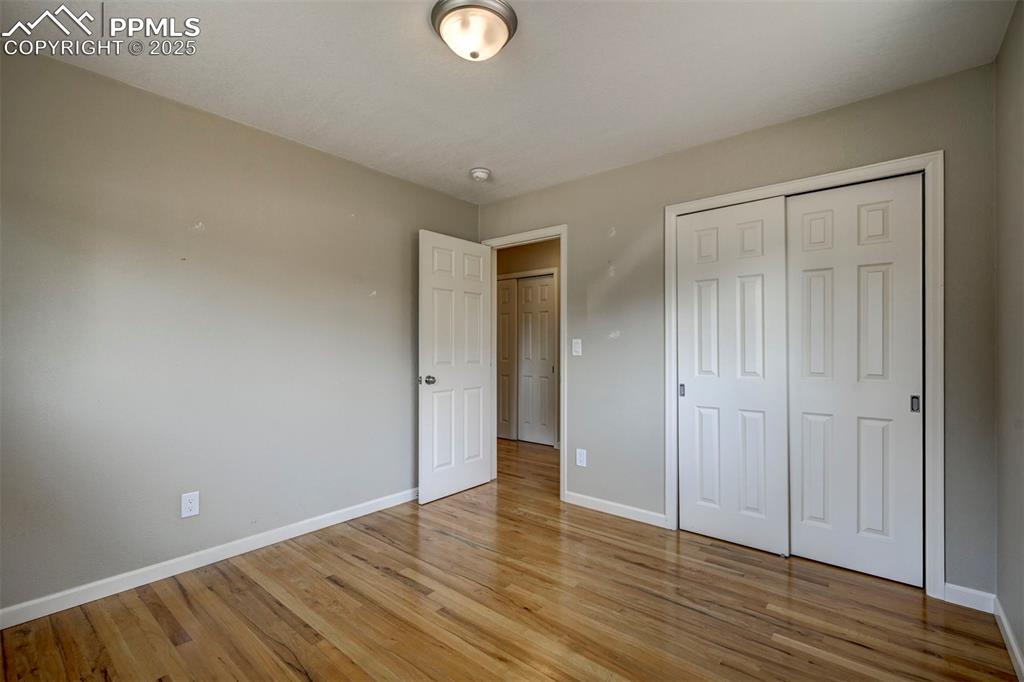 Image 26 of 33: Unfurnished bedroom featuring light wood-style floors and a closet