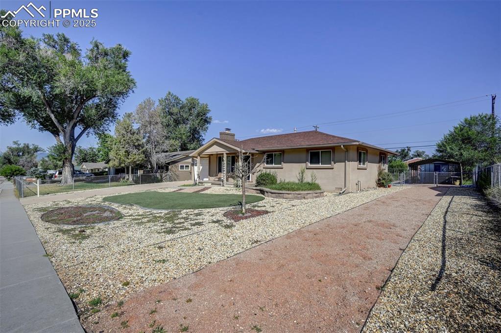 Image 3 of 33: View of front of property with stucco siding, side driveway