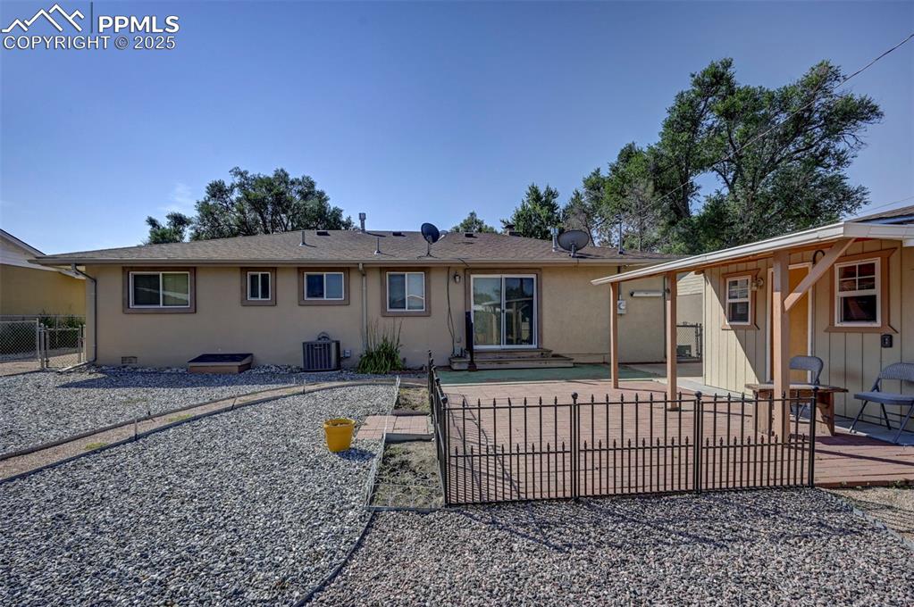 Image 30 of 33: Back of property with a patio area, a shingled roof, and stucco siding