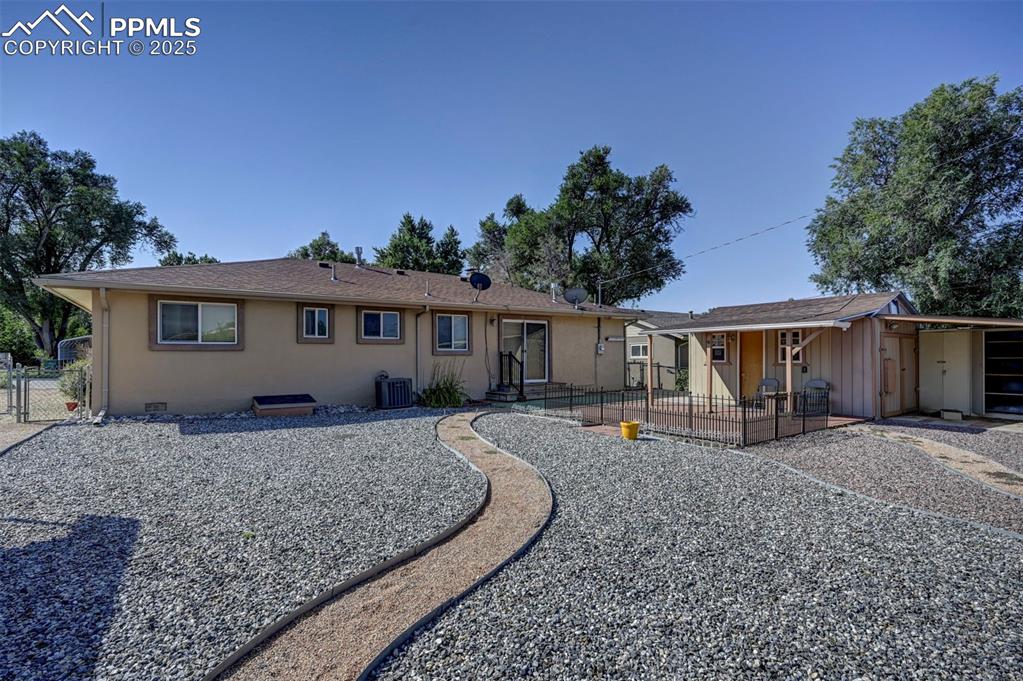 Image 31 of 33: Rear view of property featuring a patio area, a gate, stucco siding, and ro