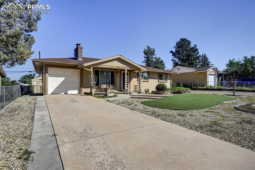 Image 4 of 33: Ranch-style house with stucco siding, concrete driveway, a garage, and a ch