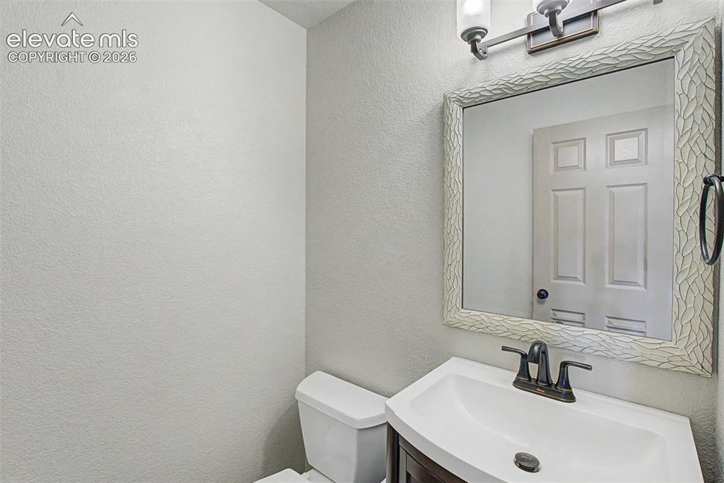 Image 10 of 40: main level primary bedroom, attached 5-piece bathroom, virtually staged
