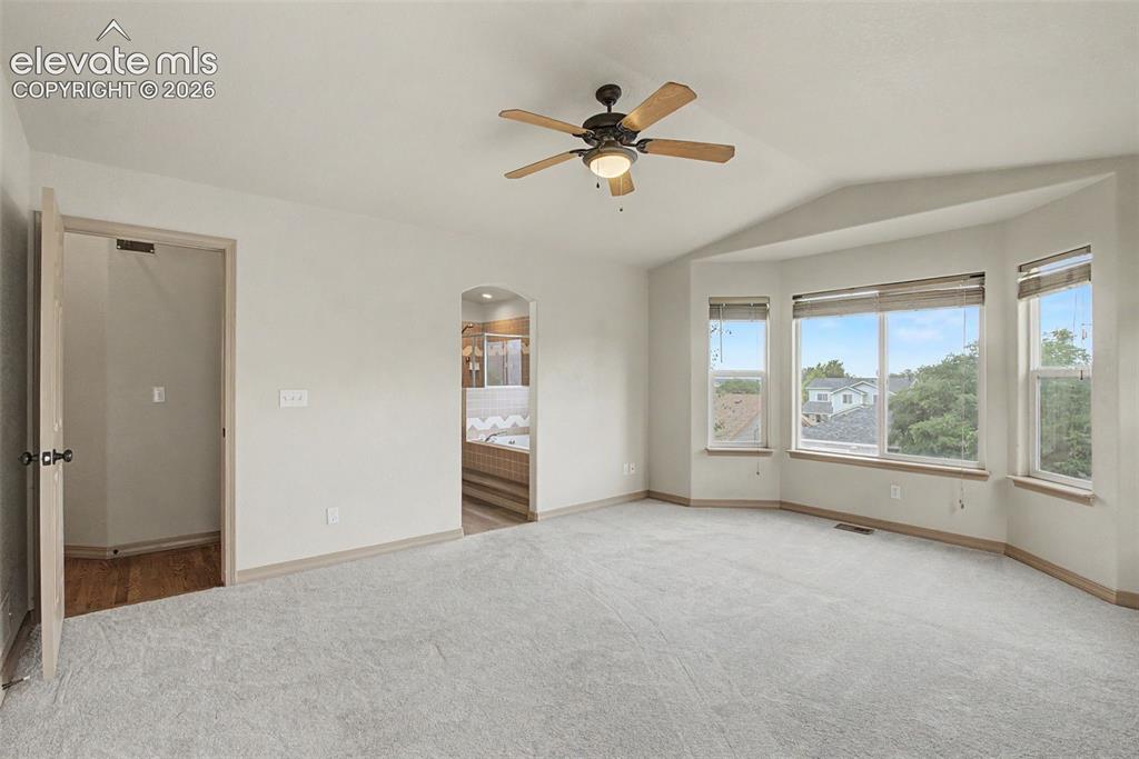 Image 13 of 40: virtually staged, 1 of 3 basement bedrooms, attached bathroom