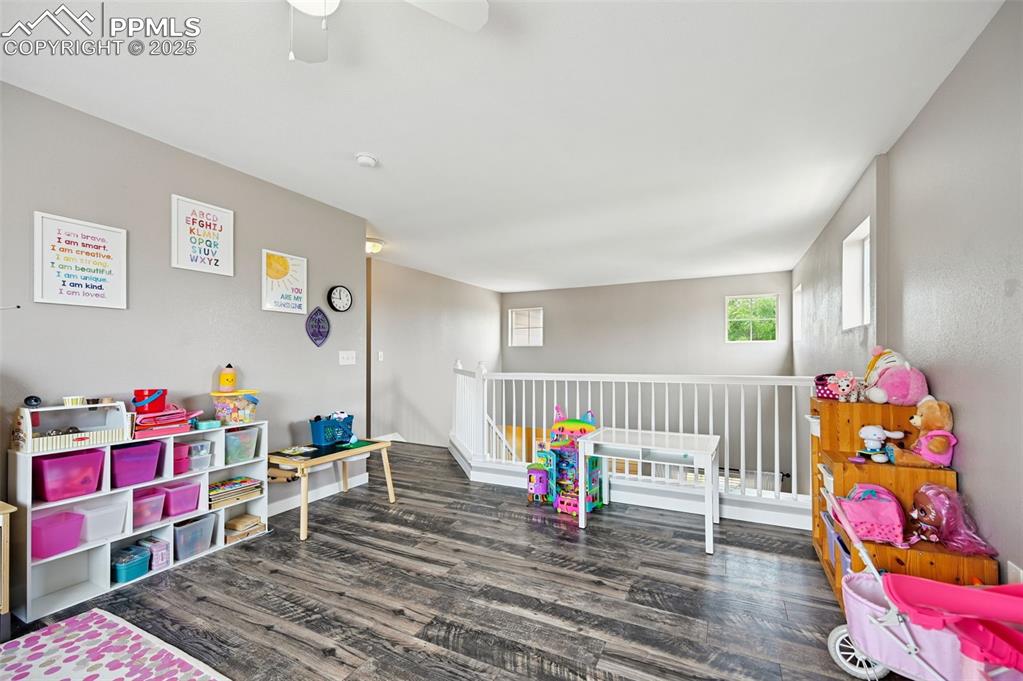 Image 17 of 29: Recreation room featuring wood finished floors and a ceiling fan