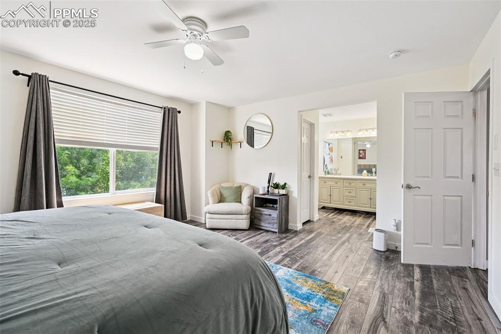 Image 19 of 29: Bedroom featuring dark wood-type flooring, ensuite bathroom, and a ceiling 