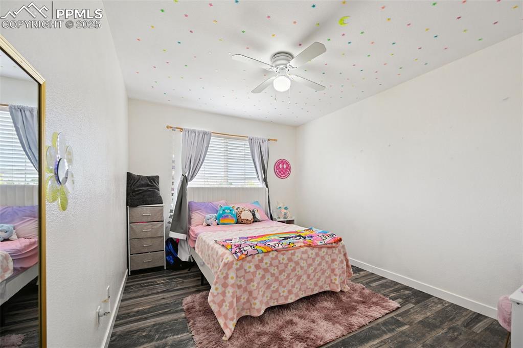 Image 23 of 29: Bedroom featuring wood finished floors and a ceiling fan