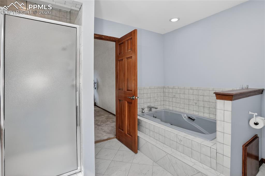 Image 13 of 30: Walk-in shower & soaking tub