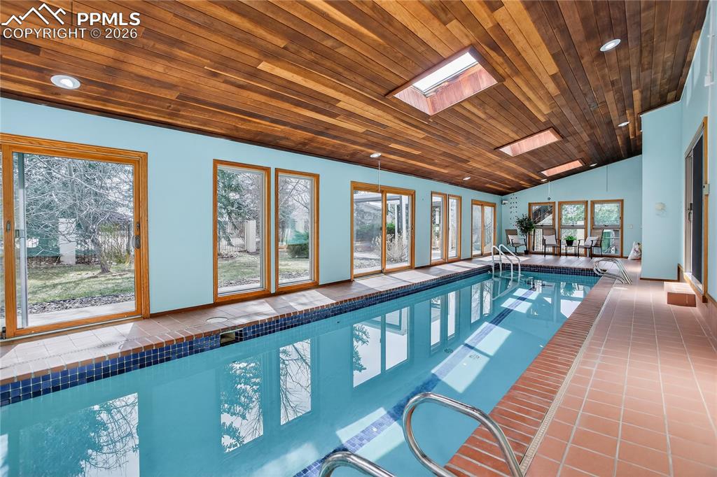 Image 21 of 30: Skylights, seating area, & walk-outs to backyard