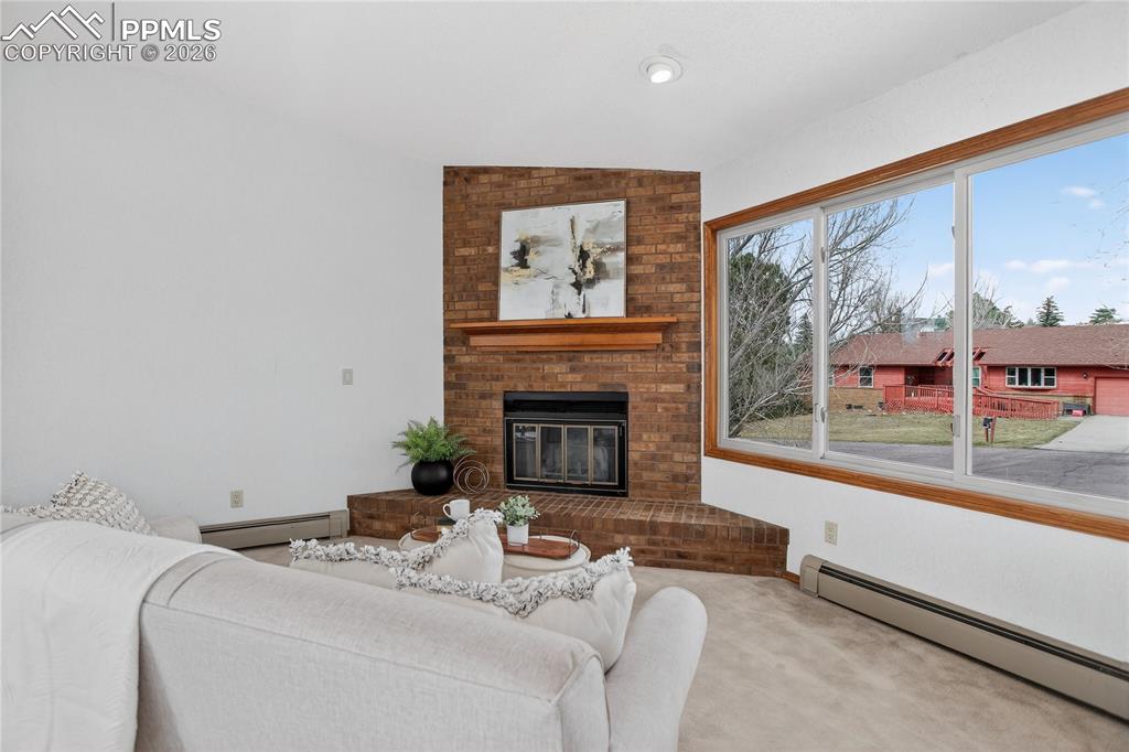 Image 3 of 30: Living room w/ fireplace