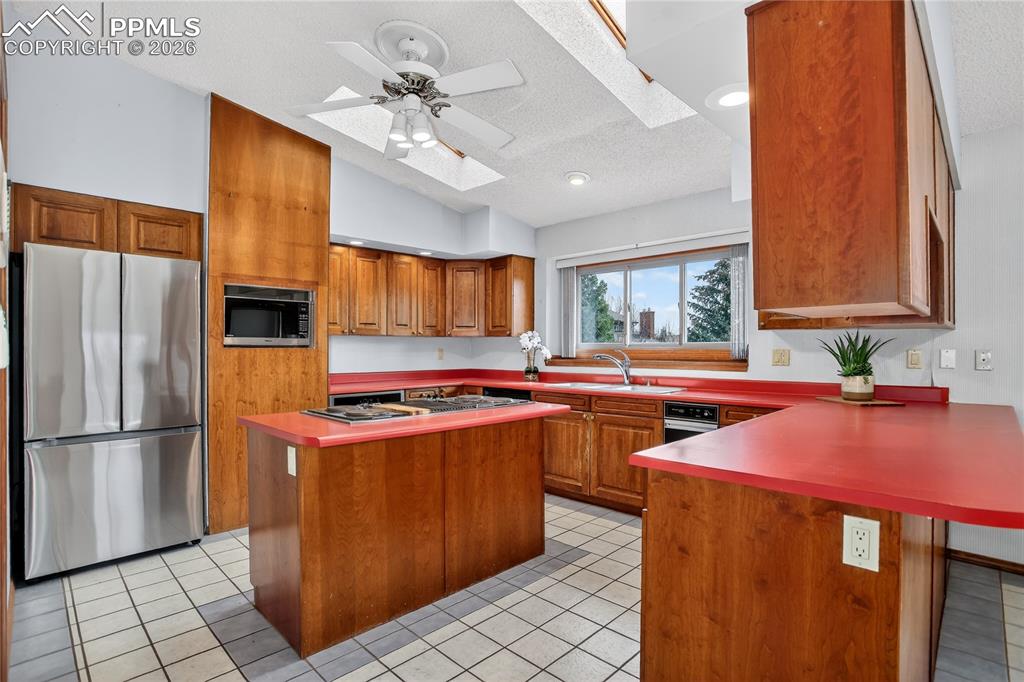 Image 9 of 30: Skylights & new SS fridge