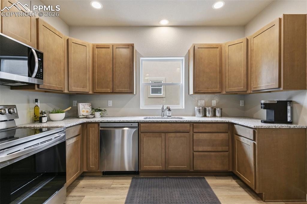 Image 9 of 24: Kitchen with appliances with stainless steel finishes, granite countertops