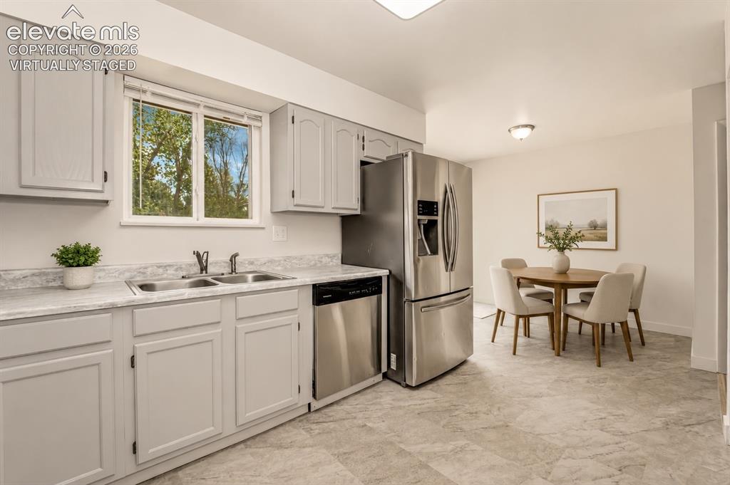 Image 6 of 31: Kitchen & Dinning Room with a Walk-out  to New Deck - Virtually Staged