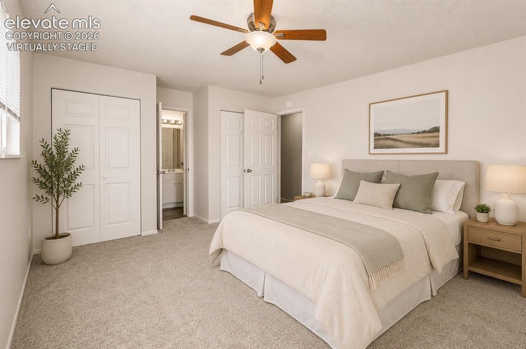 Image 9 of 31: Primary Bedroom with Adjoining Bath - Virtually Staged