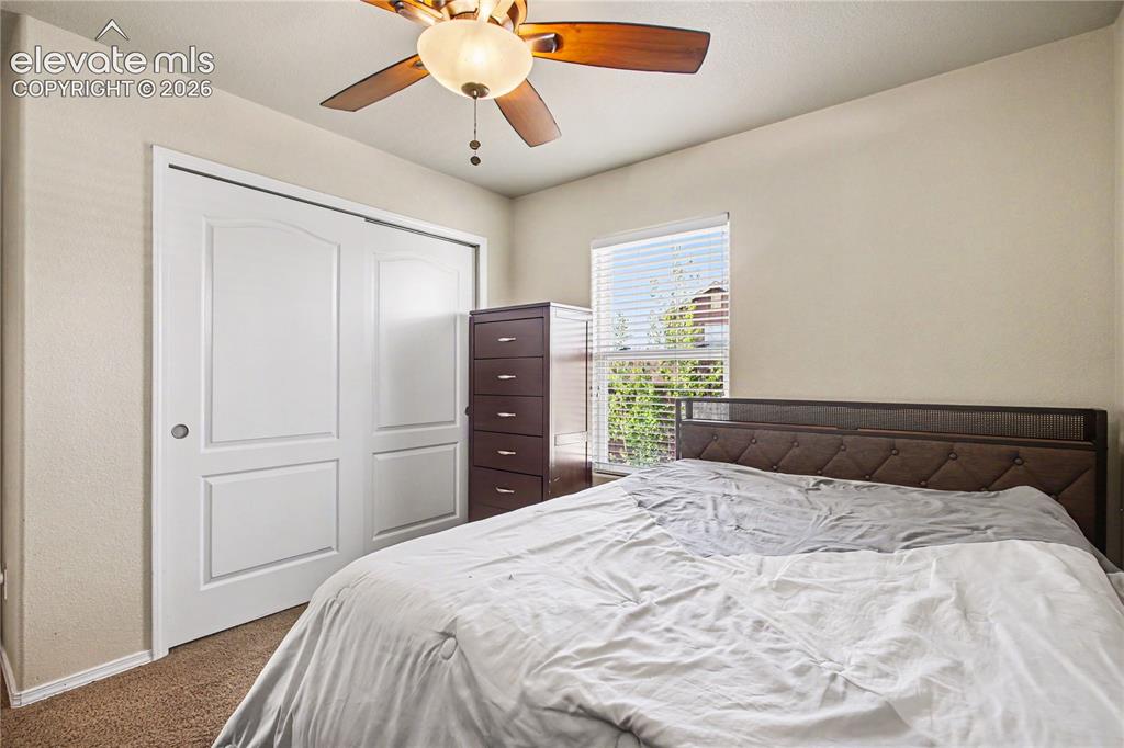 Image 19 of 41: Primary bedroom with lighted ceiling fann