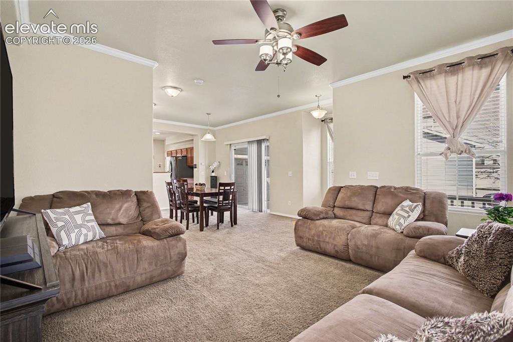 Image 8 of 41: Living room with crown molding
