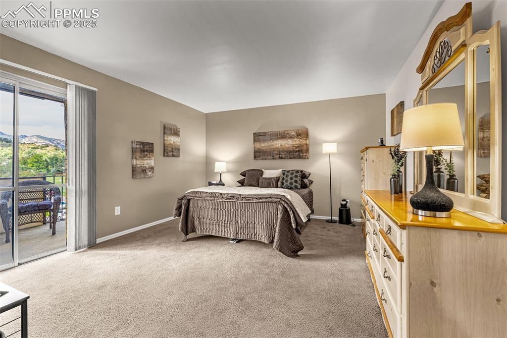 Image 13 of 24: Primary bedroom with walk-out to private balcony