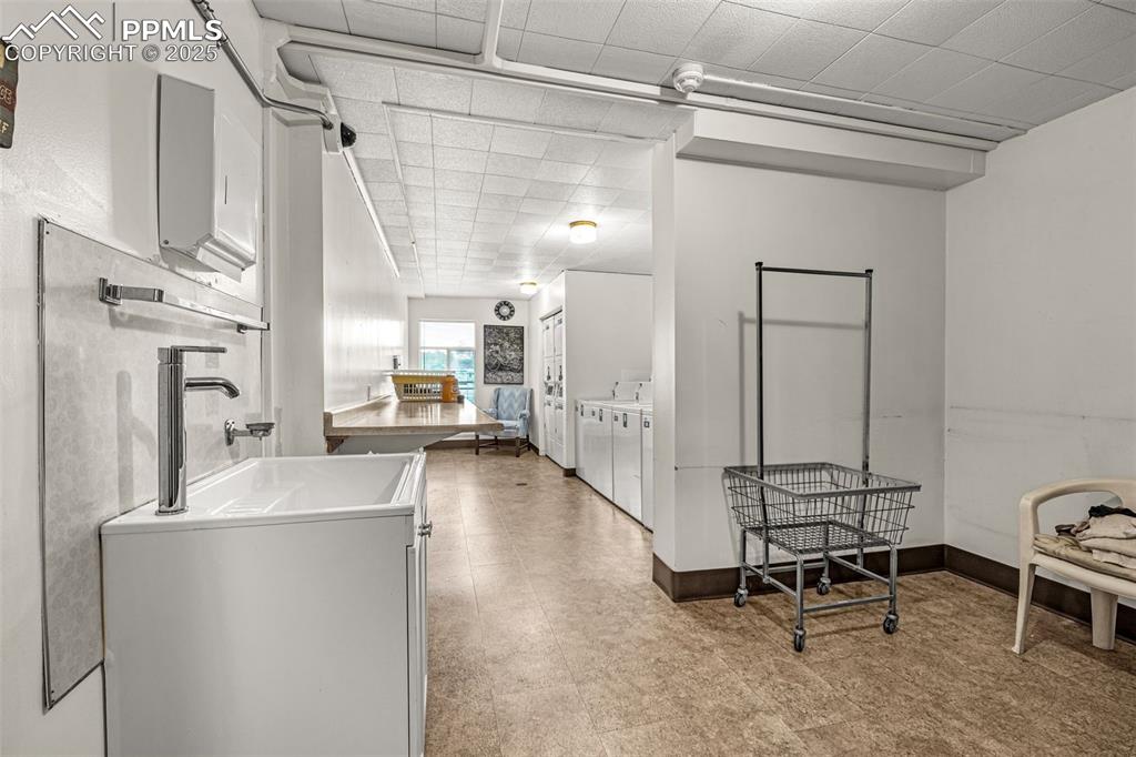Image 23 of 24: Large, clean common laundry room on main floor