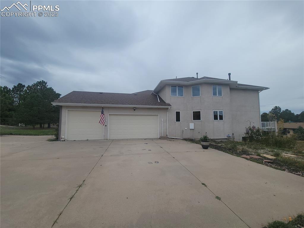 Image 3 of 42: 3 Car garage with a extra tall stall.
