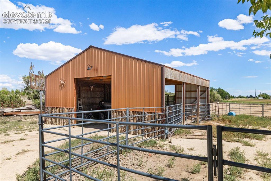 Image 25 of 41: Barn with corrals and arena