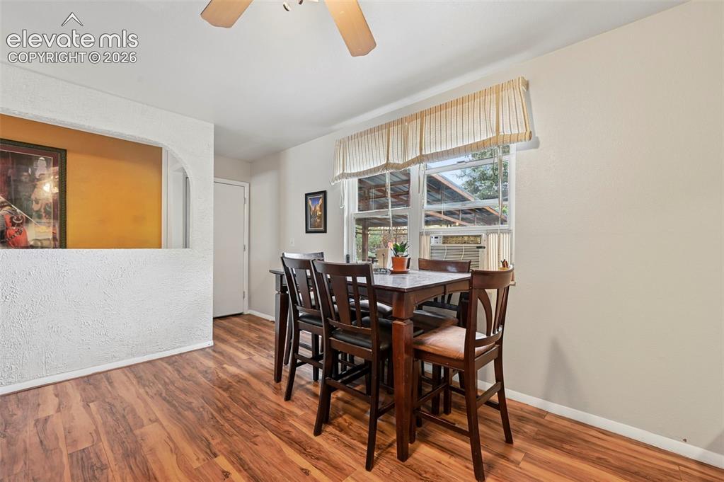 Image 10 of 33: Wood-finish flooring throughout, featuring a window with natural light, a c