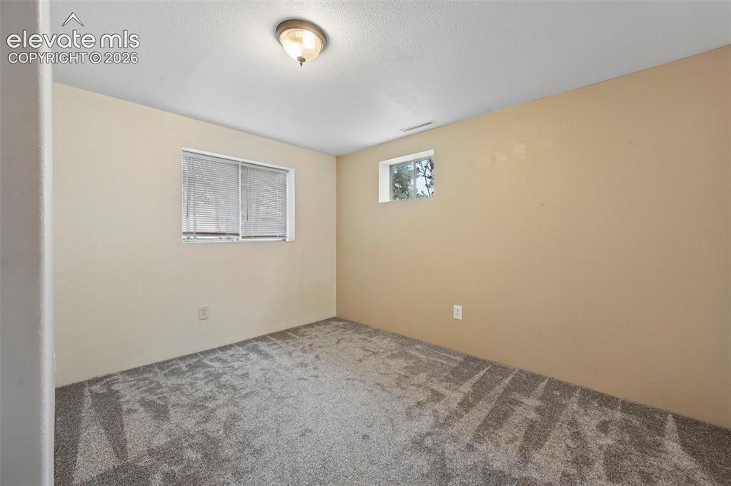 Image 22 of 33: 4th bedroom in Basement. No closet. Could be used for an office.