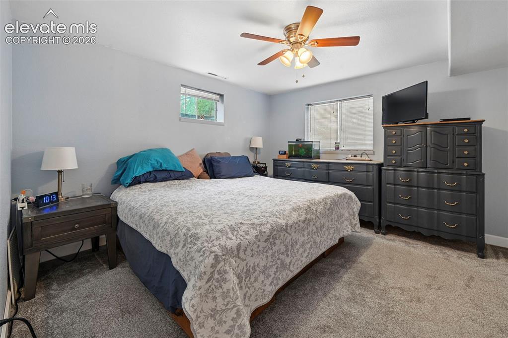 Image 25 of 33: Carpeted room featuring light gray walls, a window with horizontal blinds, 