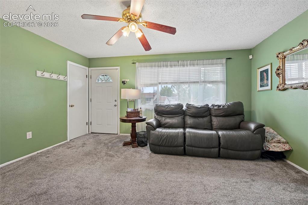 Image 5 of 33: Living Room with Ceiling Fan and closet