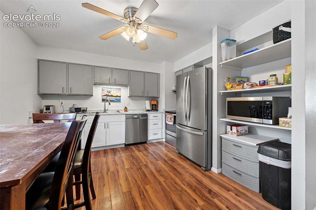 Image 7 of 33: Kitchen featuring wood-finish flooring, new lower cabinets,  stainless stee