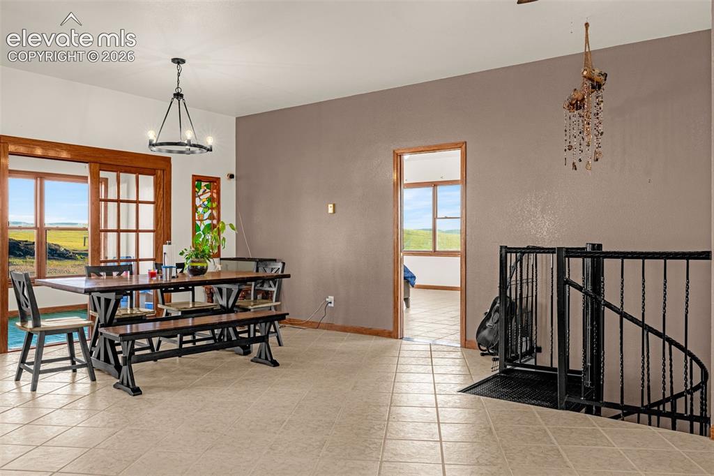 Image 12 of 50: Tiled flooring throughout, wood-framed sliding glass doors, built-in staine