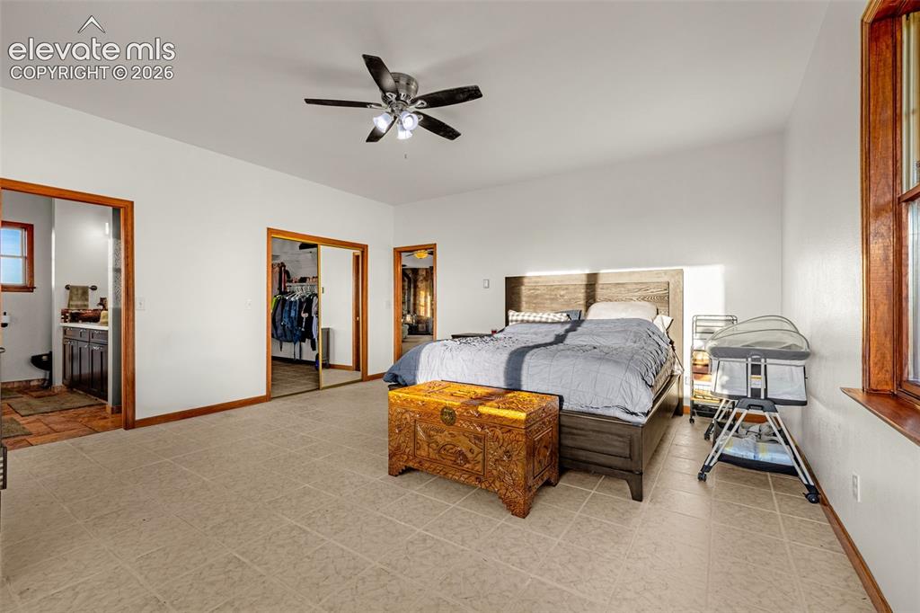 Image 20 of 50: Expansive room with tiled flooring and a ceiling fan