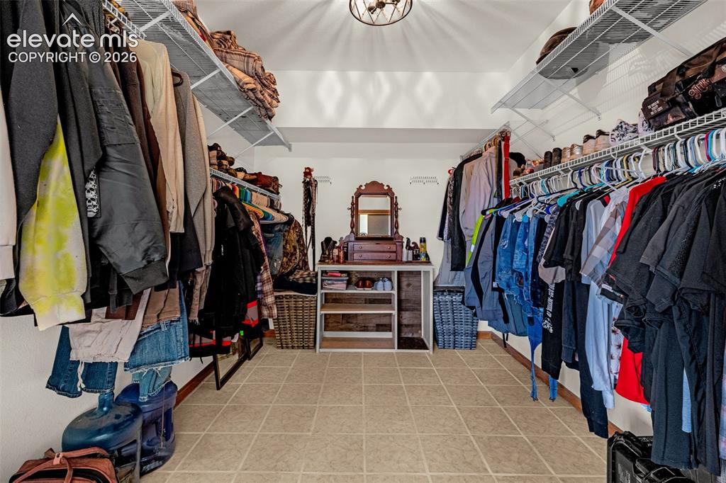 Image 24 of 50: Walk-in closet featuring floor-to-ceiling adjustable wire shelving, ample h
