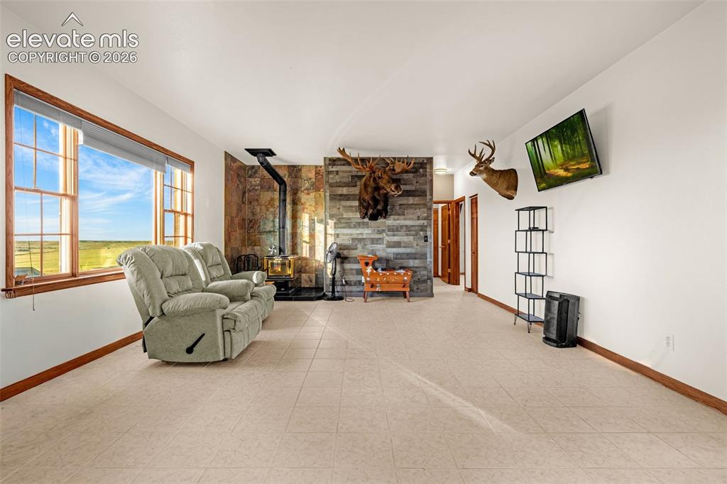 Image 26 of 50: Spacious interior with neutral-toned flooring, large window offering expans