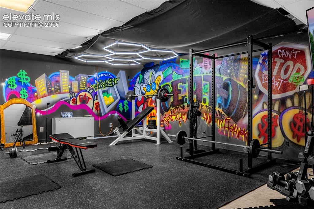 Image 29 of 50: Custom-designed interior space with vibrant wall art, recessed lighting, an