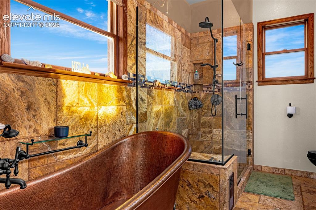 Image 4 of 50: Freestanding copper soaking tub with dark-finish hardware