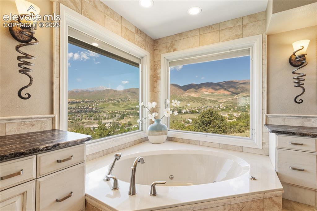 Image 29 of 50: Jetted Soaking Tub is Perfectly Positioned to Capture Framed Views of Pikes