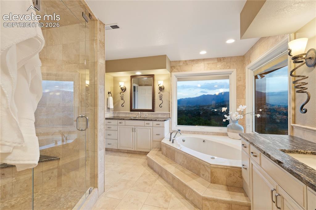 Image 32 of 50: Spa-Like Primary Bath Finished with Travertine Tile!