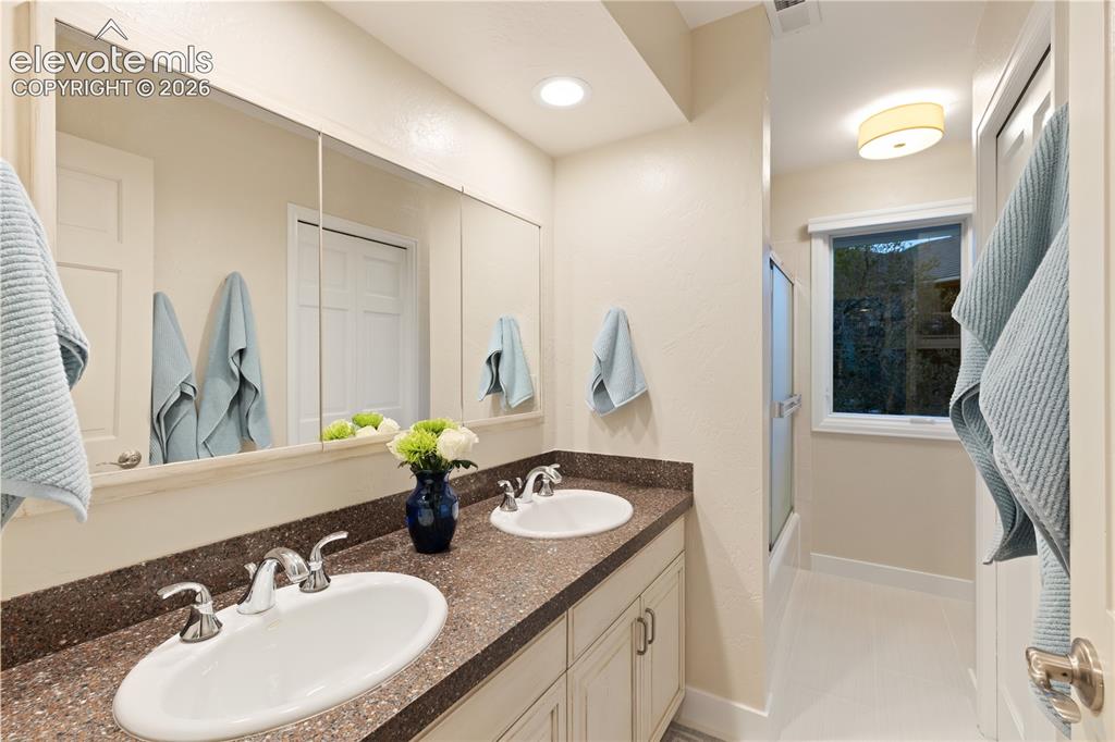 Image 34 of 50: Full Upstairs Bathroom with Dual Vanities!